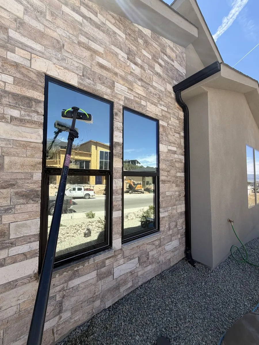 Stone-accented home with two matching windows cleaned