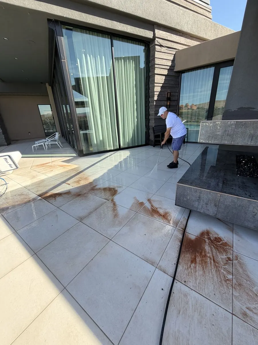 Pressure washing rust stains off a tile patio