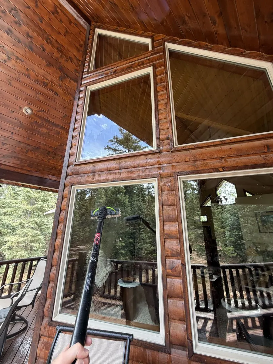 Cabin-style window wall cleaned, wood beam ceiling