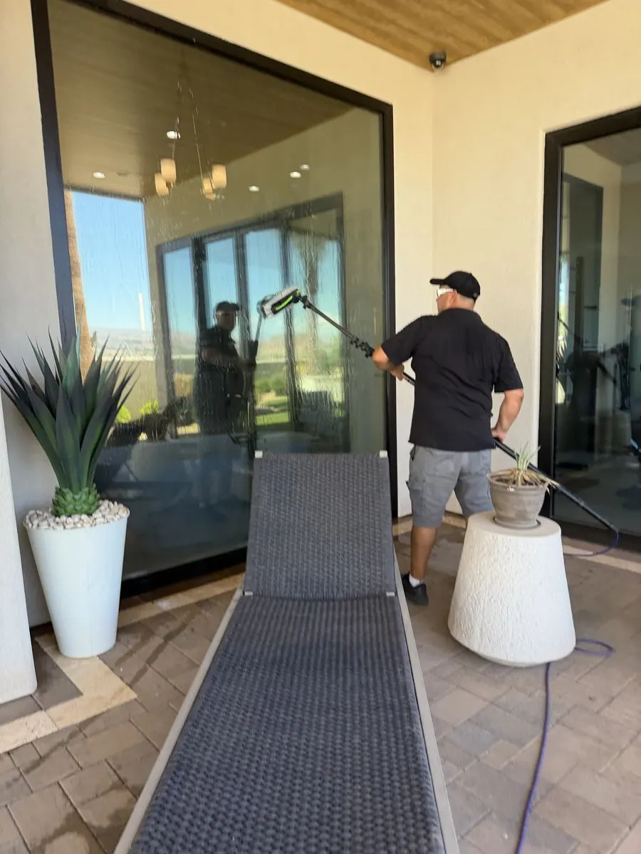 Sliding glass door reflecting a covered patio and mountain view