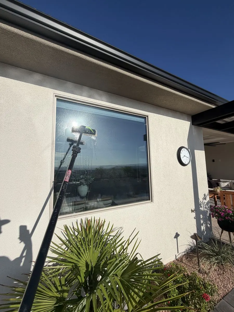 Corner window cleaned under a gabled roofline