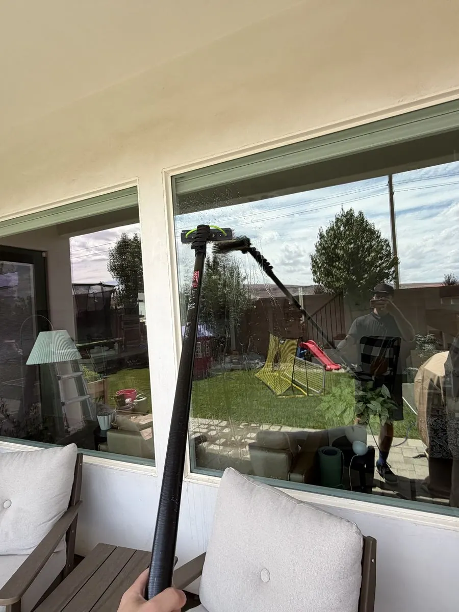 Sunroom windows cleaned, patio furniture reflected