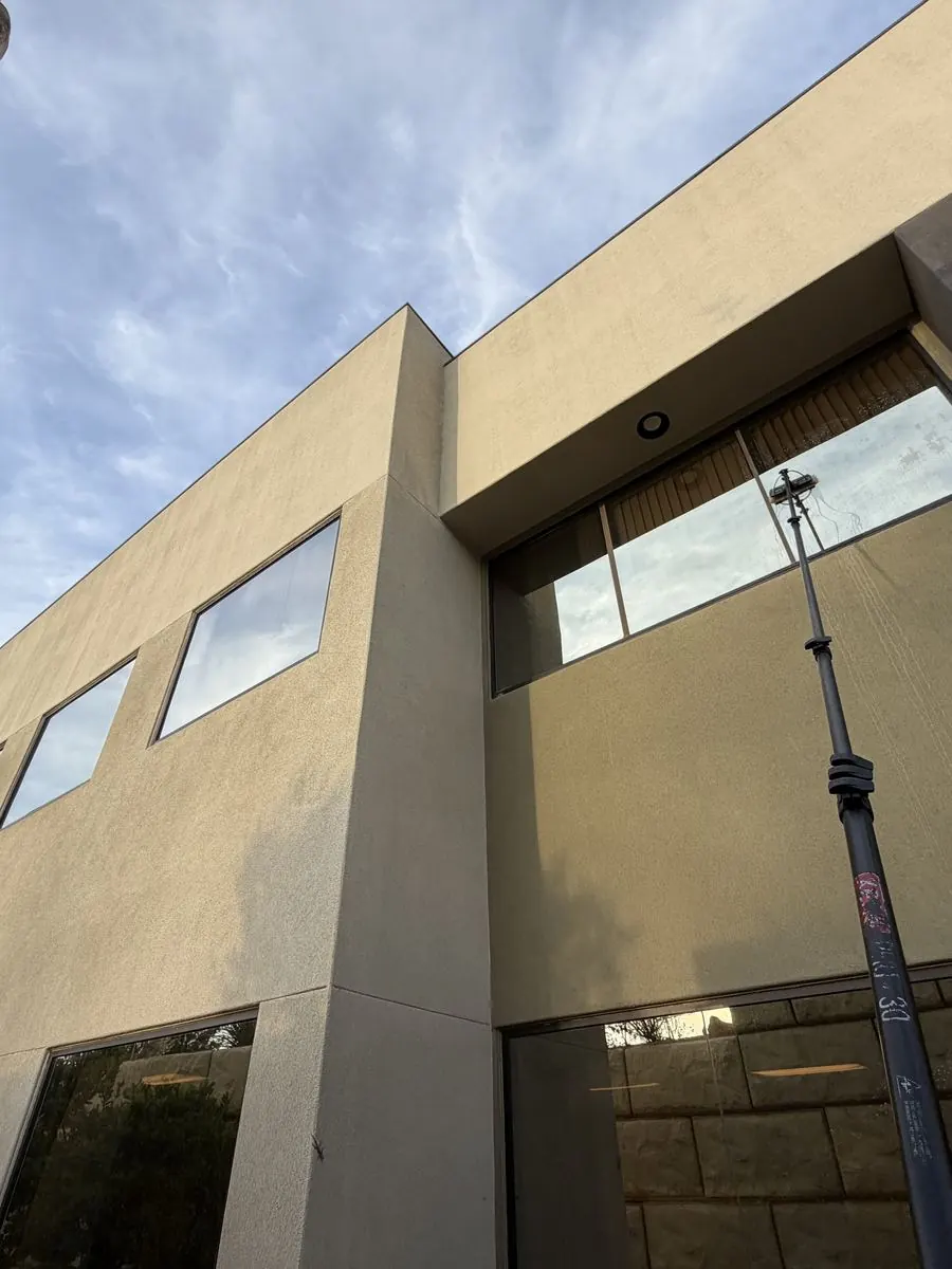 Extension-pole cleaning on a tall building corner
