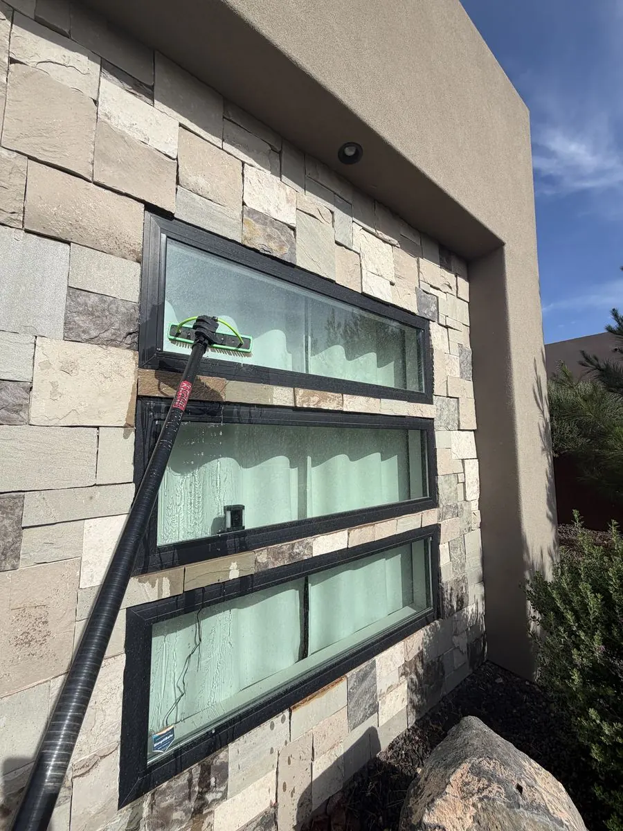 Covered patio window cleaned, furniture reflected in the glass
