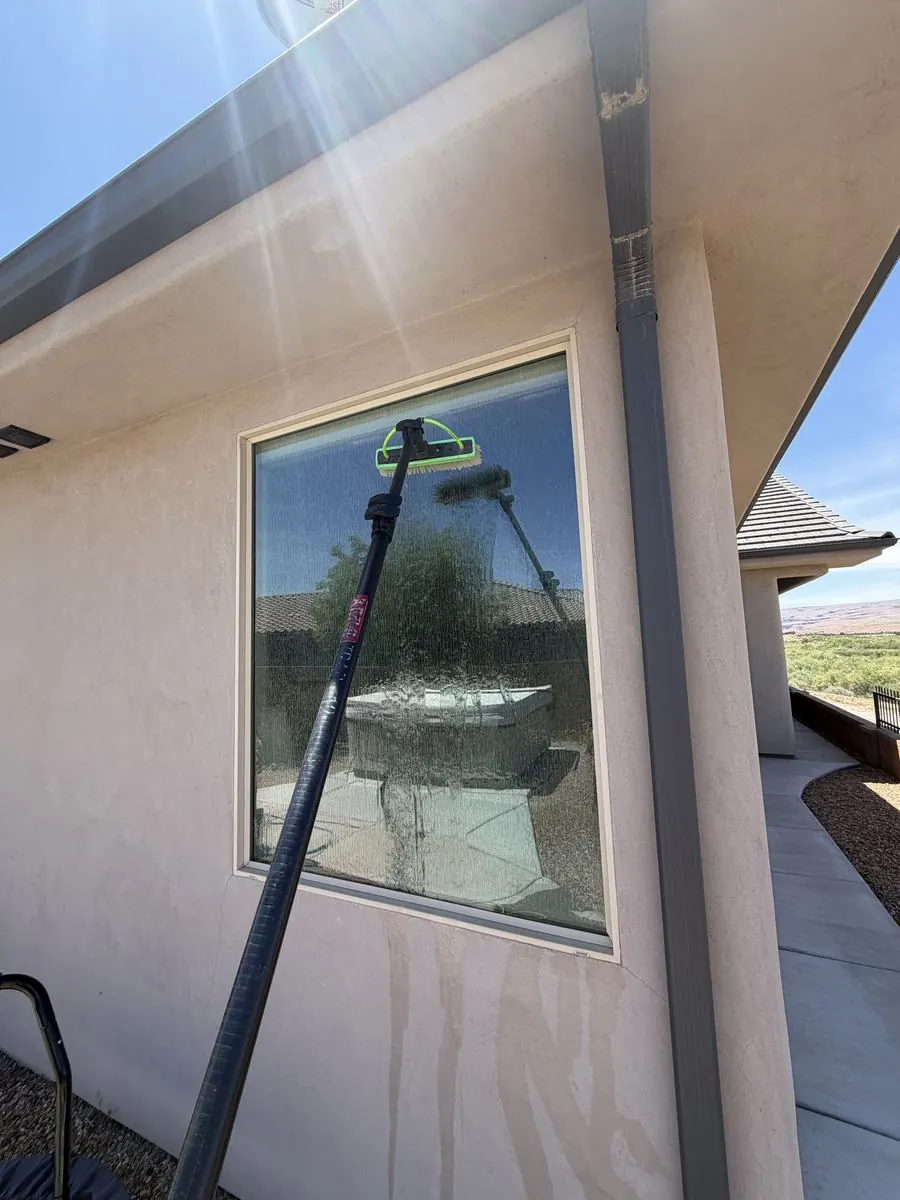 Window cleaned, red rock landscaping reflected in the glass